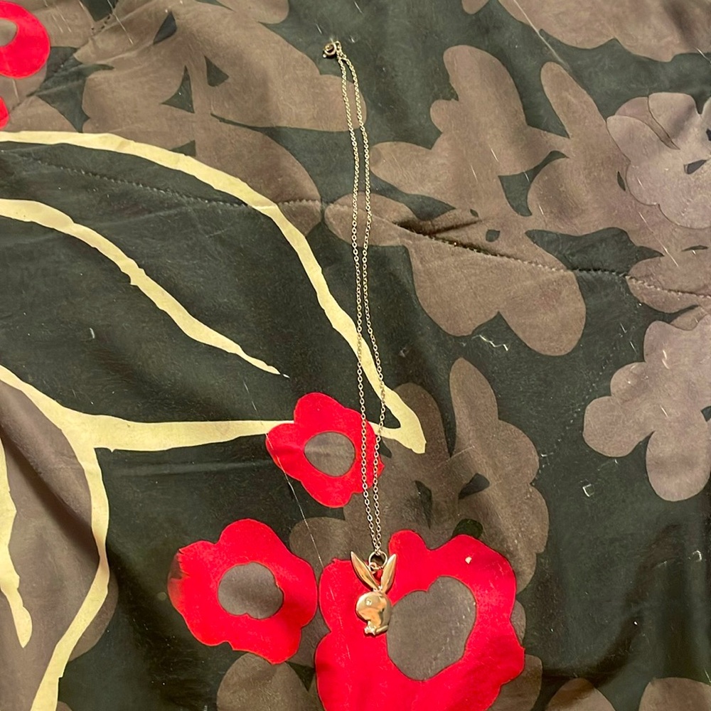 Silver playboy necklace.